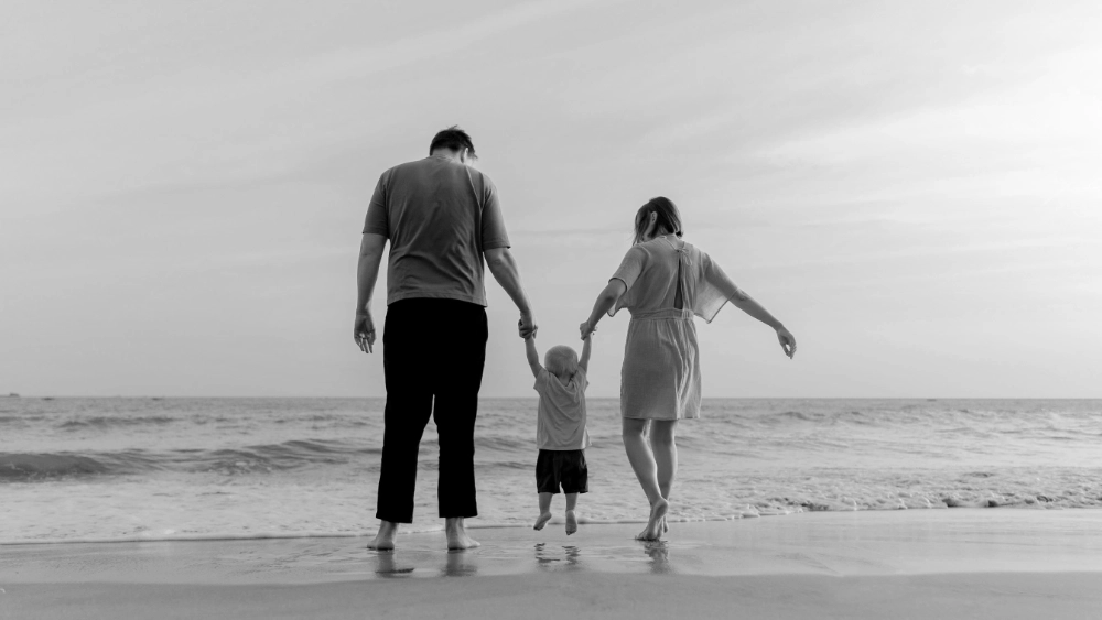 Couple with toddler on beach