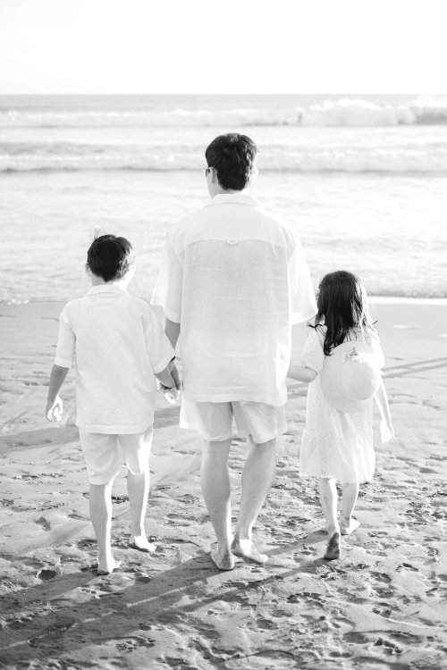 Father with children walking on beach
